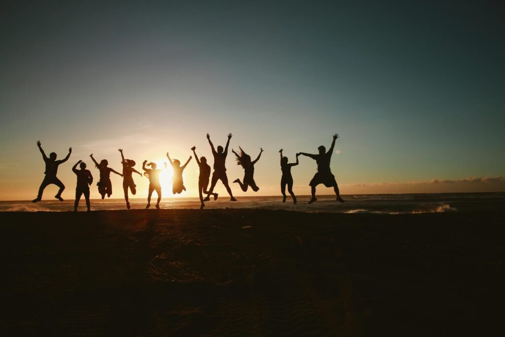 image for the about healing hearts therapy section. Showing a group of 11 friends jumping with the sunset in the background